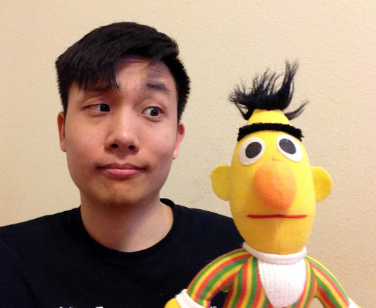 Photo of Bert the designer looking at Bert the Muppet.